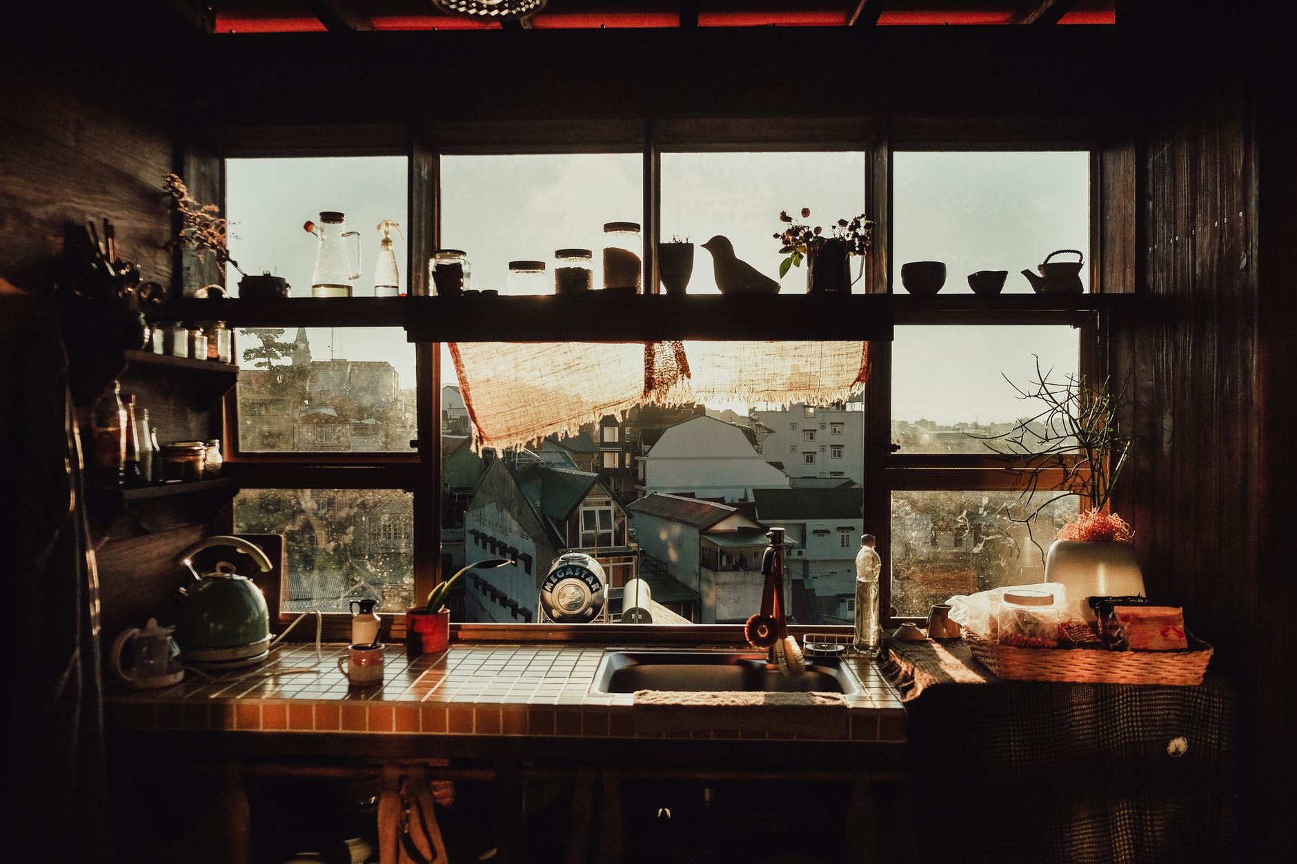 Charming rustic kitchen with a view, filled with sunlight and vintage details.